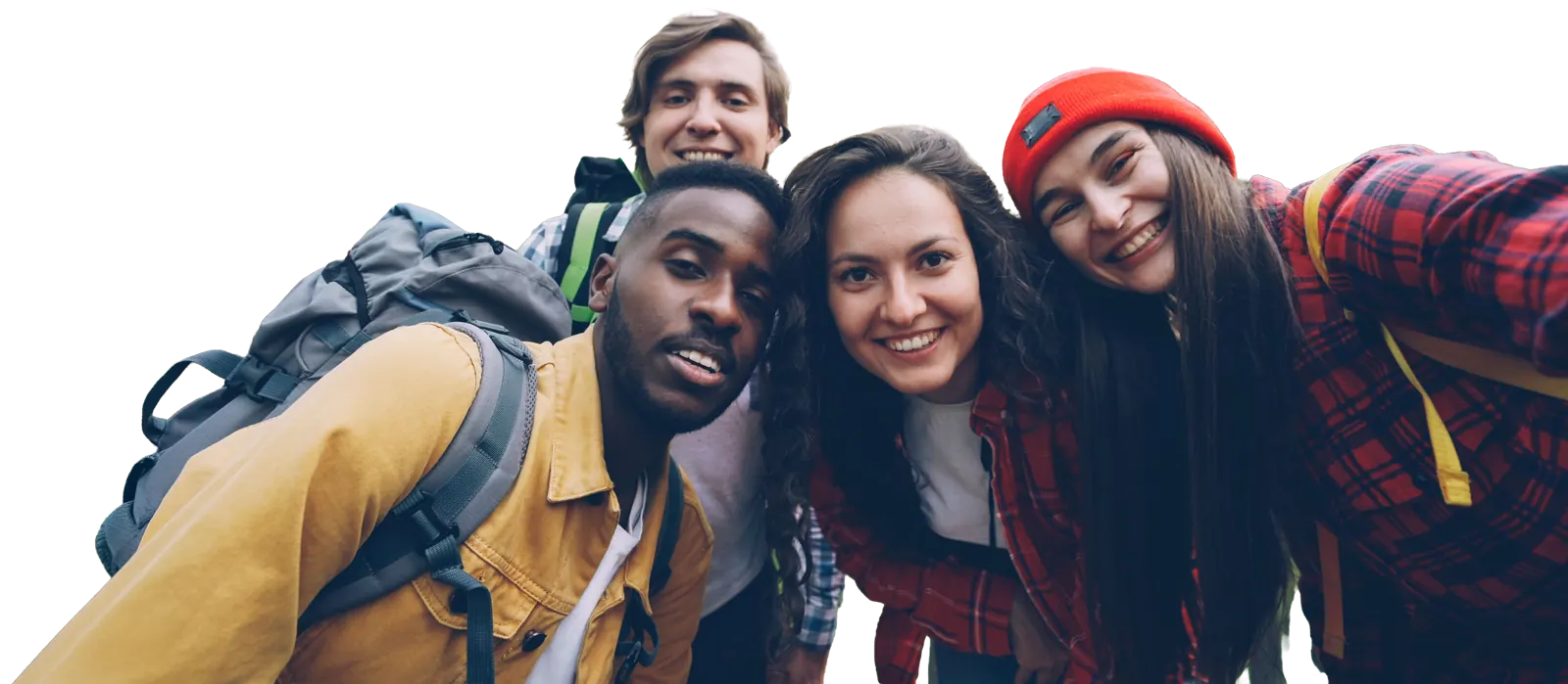 Four friends with backpacks taking a selfie in the woods